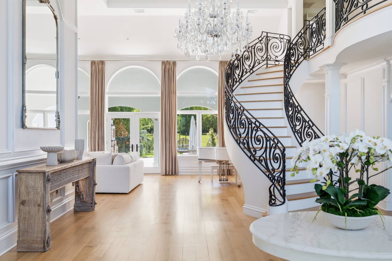 Grand foyer with crystal chandelier and curved staircase