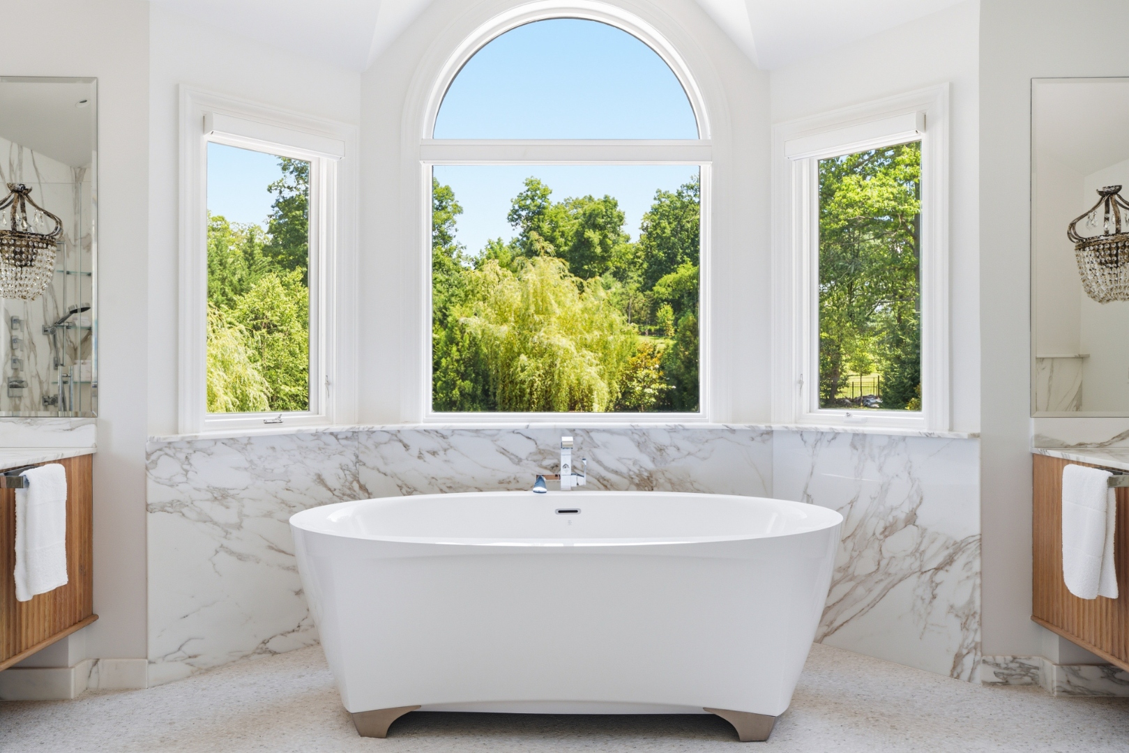 Spa-inspired primary bath with soaking tub and skylight